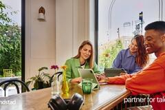 Grupo de compañeros sonrientes en una oficina.
