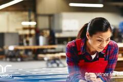 mujer en una fábrica trabajando.
