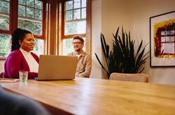 una mujer y un hombre platicando en la oficina.